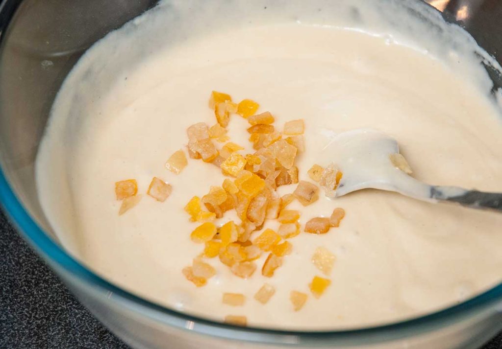 Adding candied fruit to rum-punch Lamington batter.