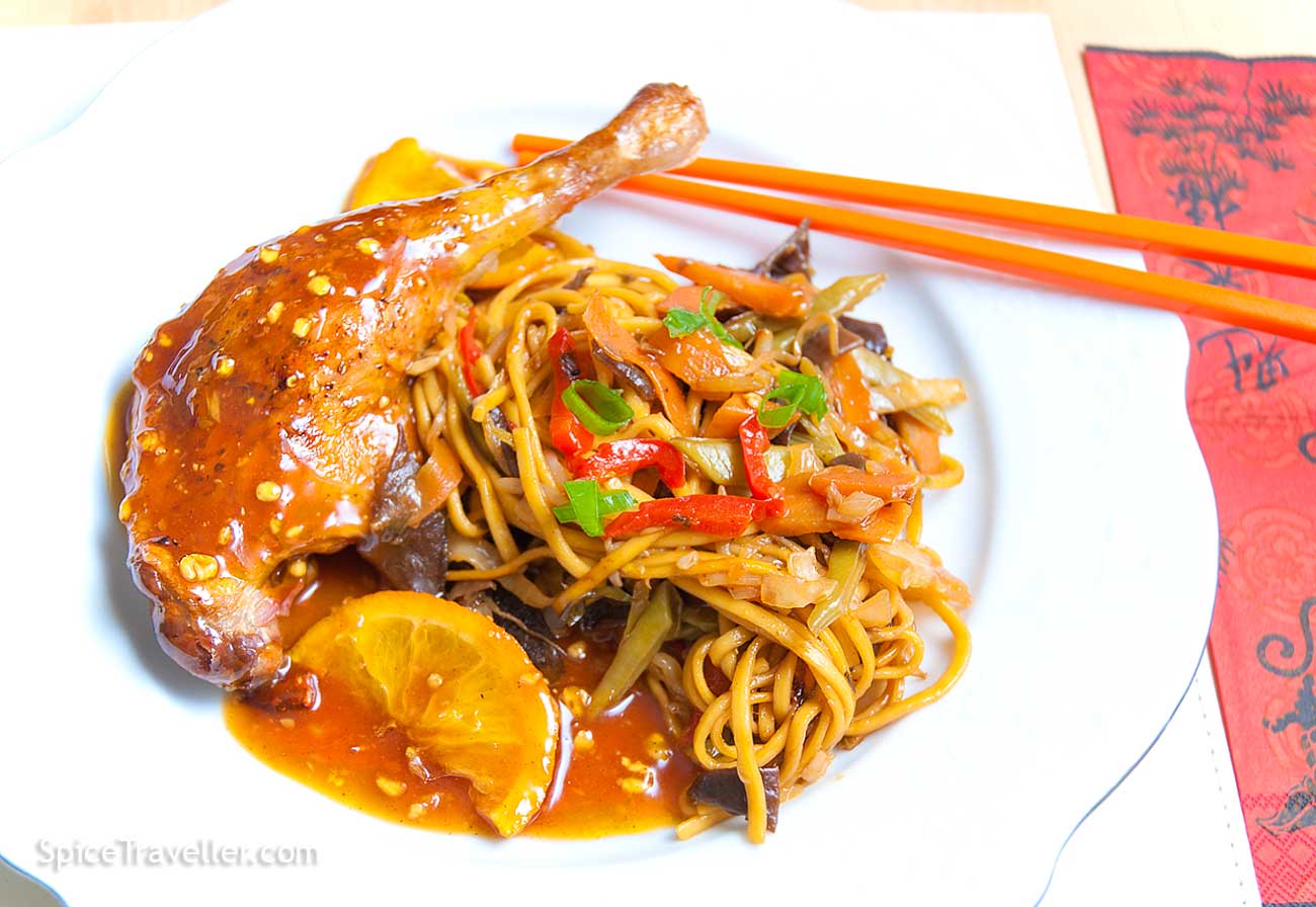 Deliciour Chinese chicken leg with orange sauce and noodles