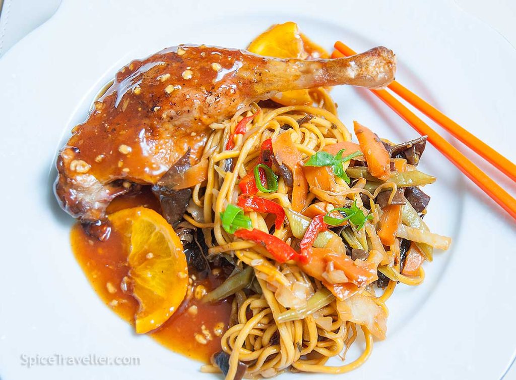 Serving suggestion - chicken leg with sticky orange sauce and vegetable noodles.