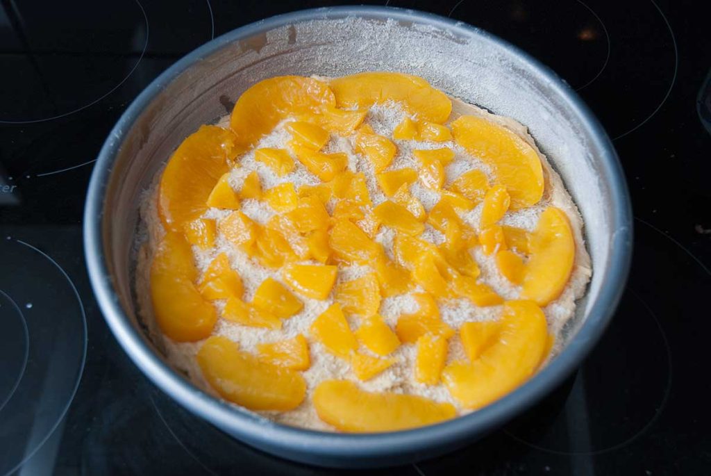 Coconut and peach cake ready to bake.