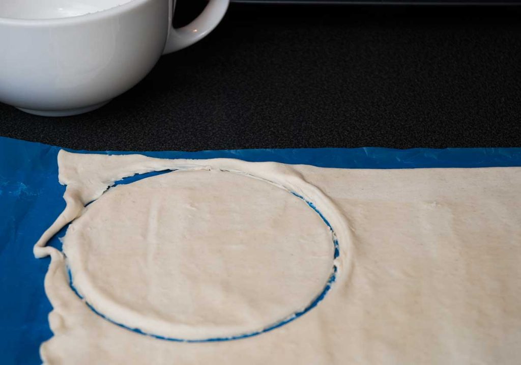 One cut out circle of puff pastru dough.