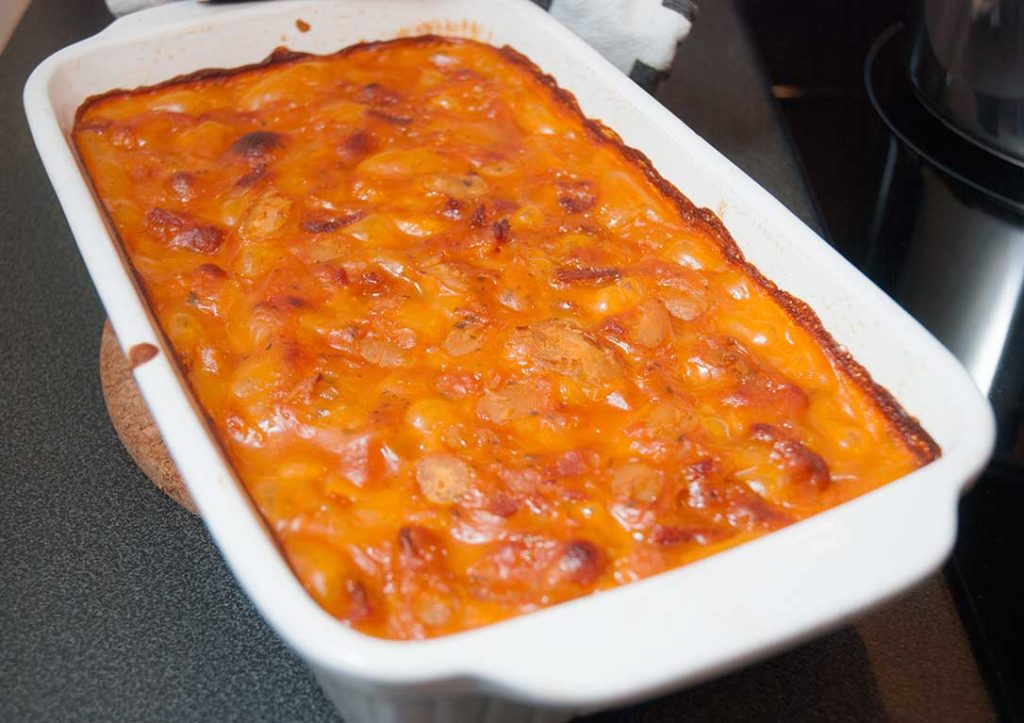 Freshly baked Traditional Croatian butter beans in a white casserole dish with a golden, slightly crisped surface.