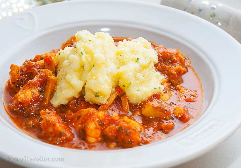 Close up of Italian Brodetto - fish and seafood stew with polenta.