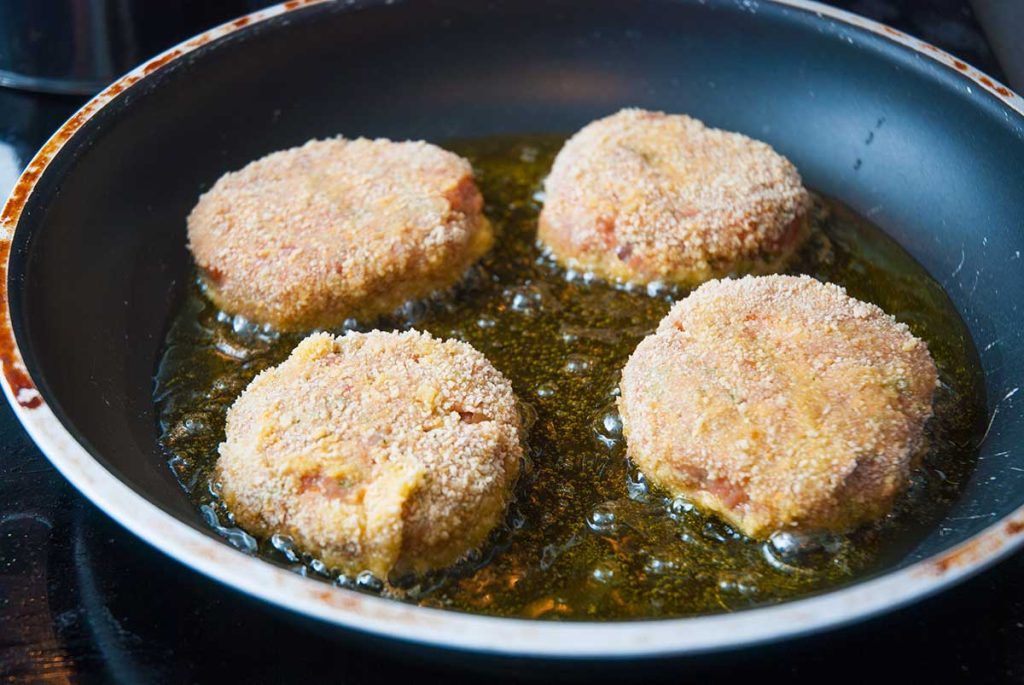 Shallow frying breaded Australian beef patties - rissoles.