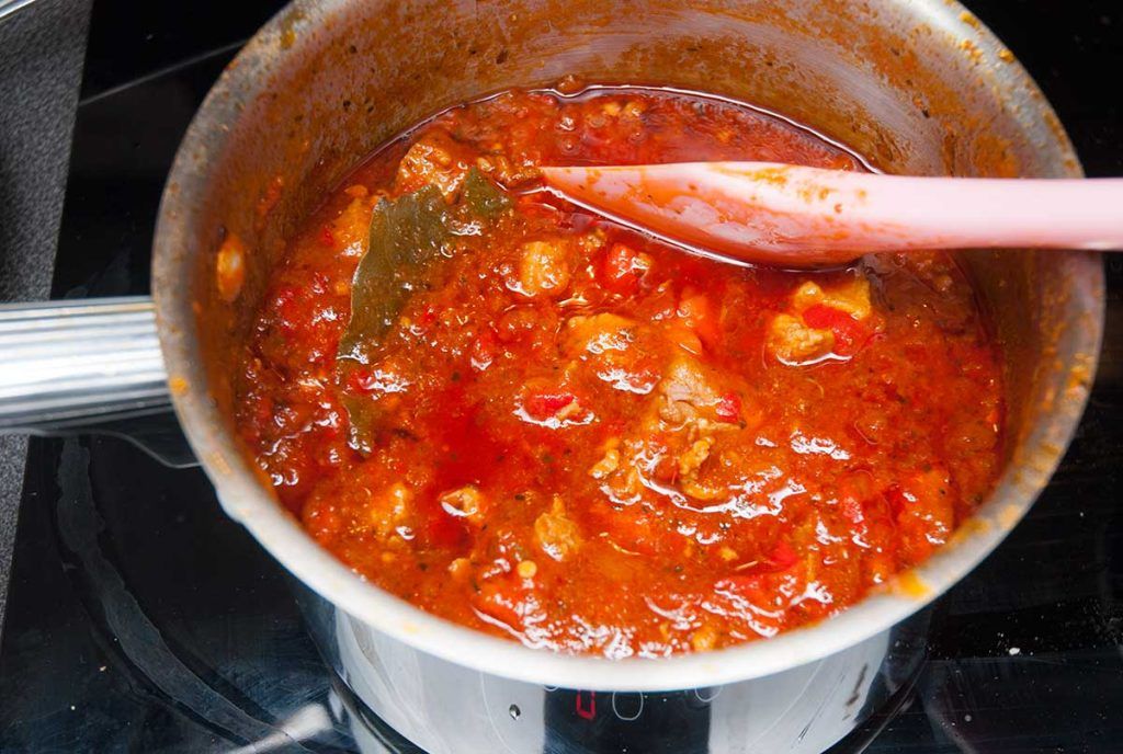 Finished thick pork stew in a pot, ready to fill burritos.