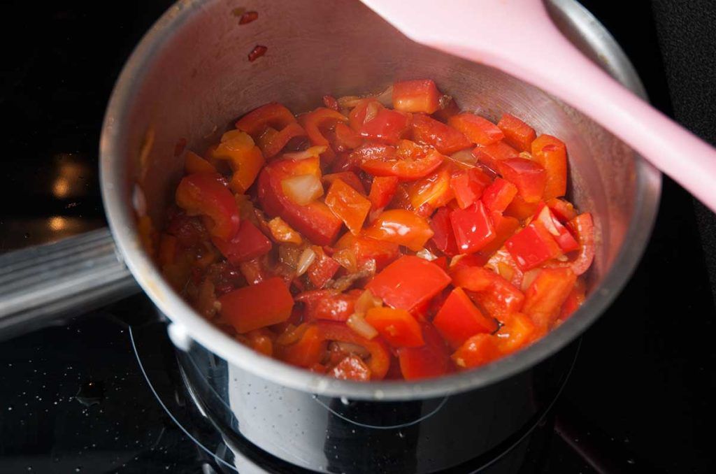 Frying red bell peppers.