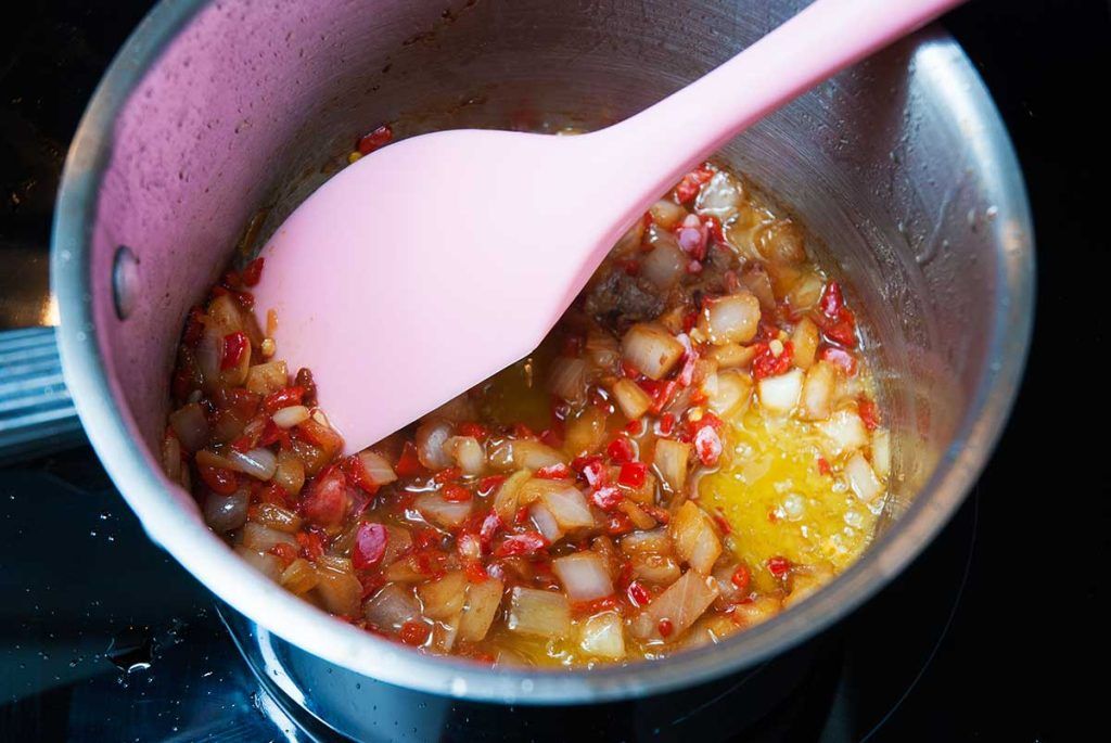 Frying onion and chilli peppers.