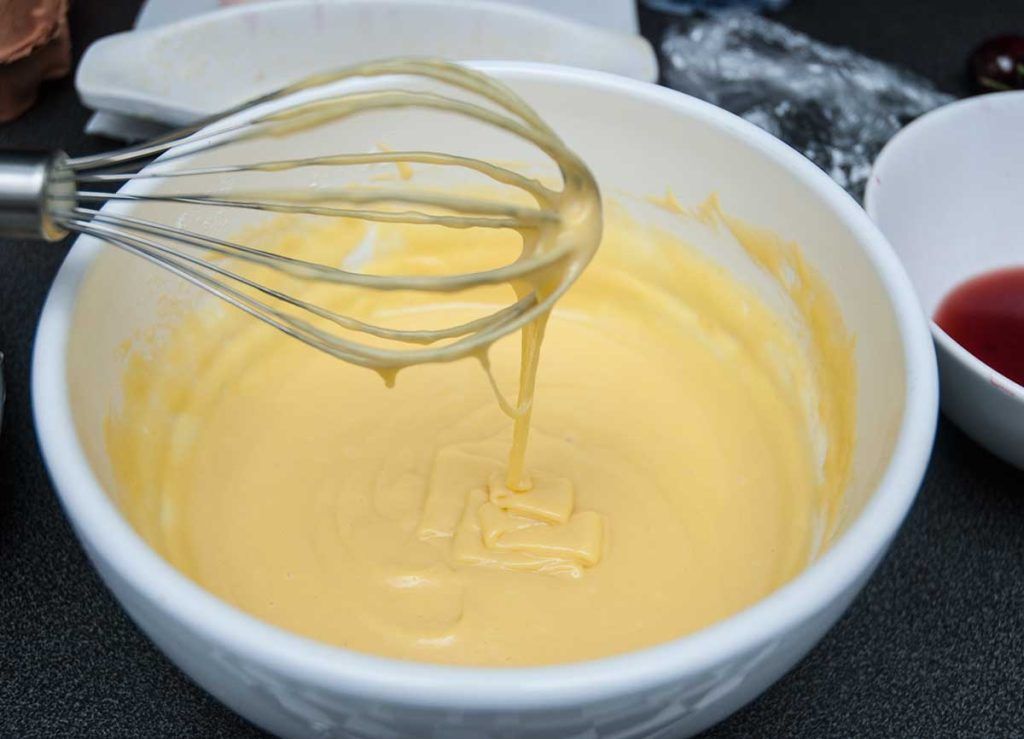 Making batter for Clafoutis - French custard cake with cherries.