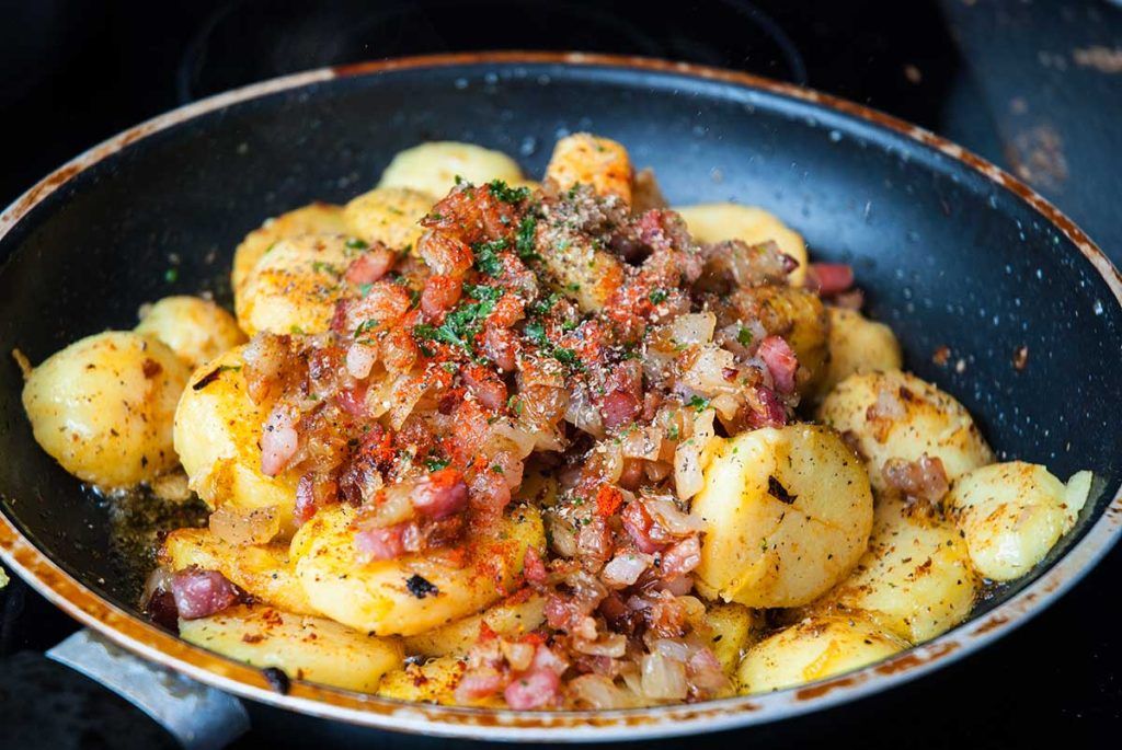 Onion, bacon, and herbs added back to the browned potatoes.
