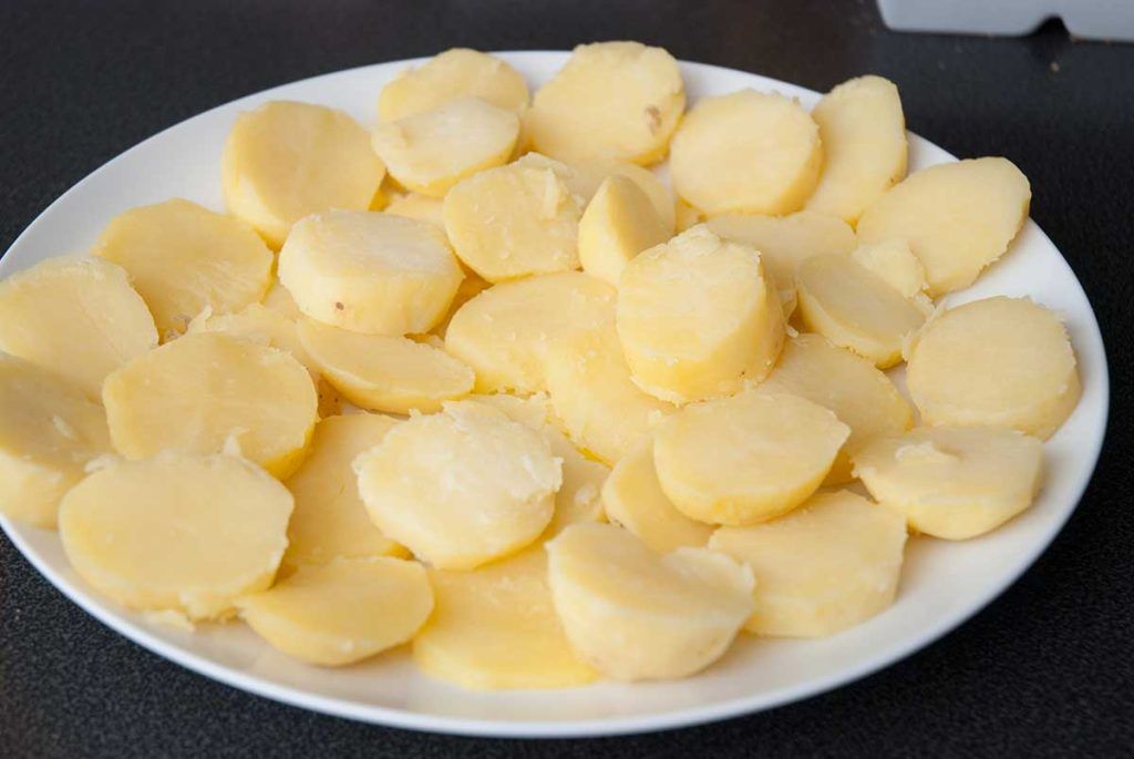 Chilled, sliced cooked potatoes ready for pan-frying