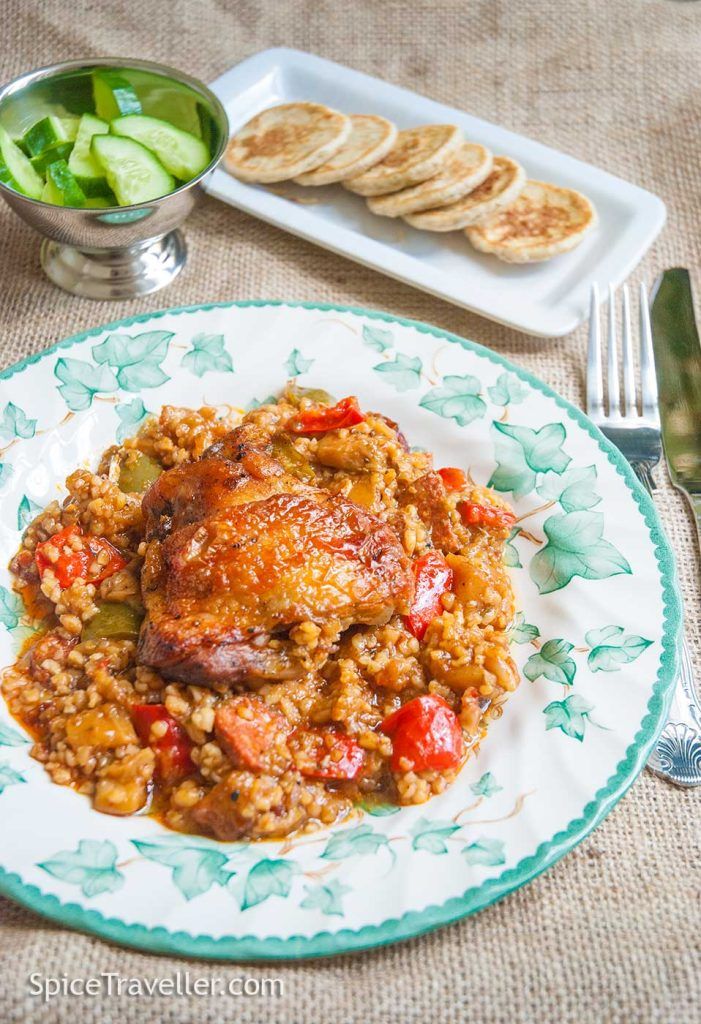 Turkish chicken and bulgur bake (guvec) served with cucumber and mini pita bread.