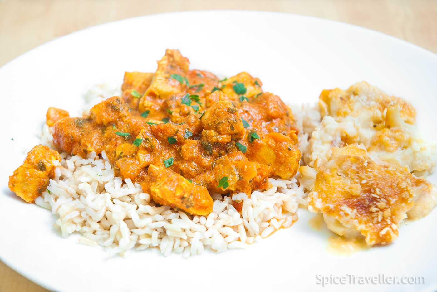Close up of simple chicken tikka masala served over plain rice.