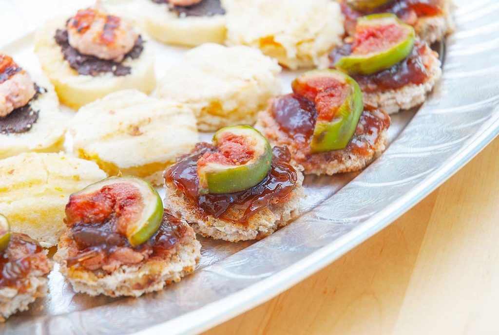 Close up of duck pate with red onion chutney and fig canapés.