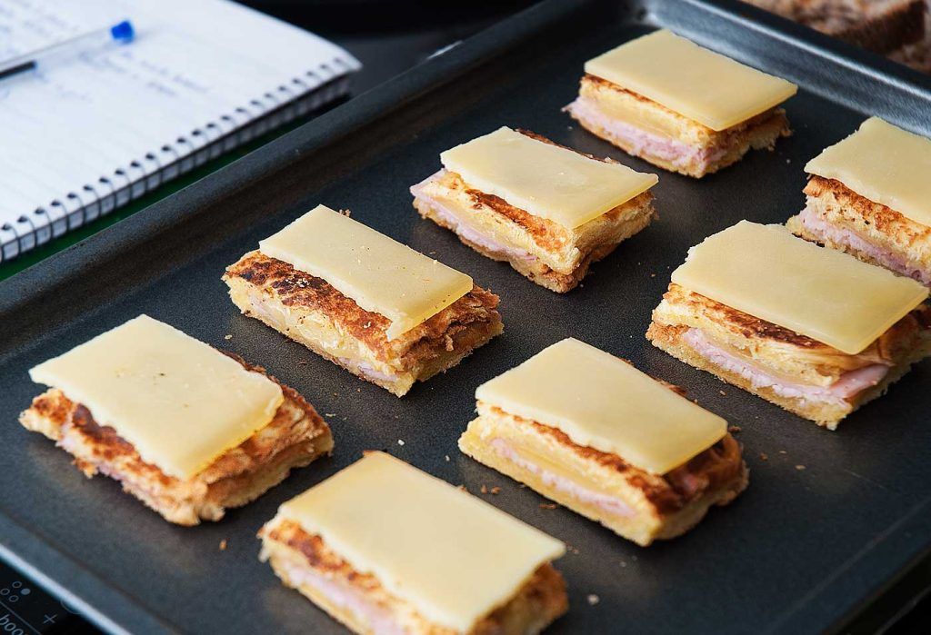 Mini Croque Monsieur with Truffle canapes on a tray before grilling.