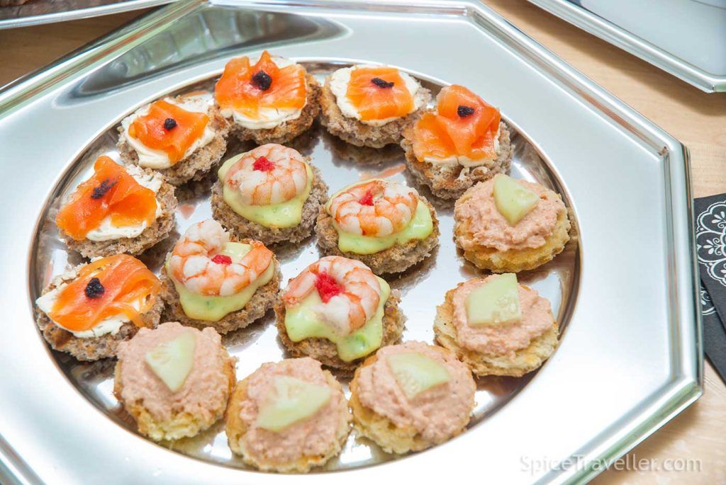 Fish and seafood Monte Carlo Canapés selection , served on silver tray.