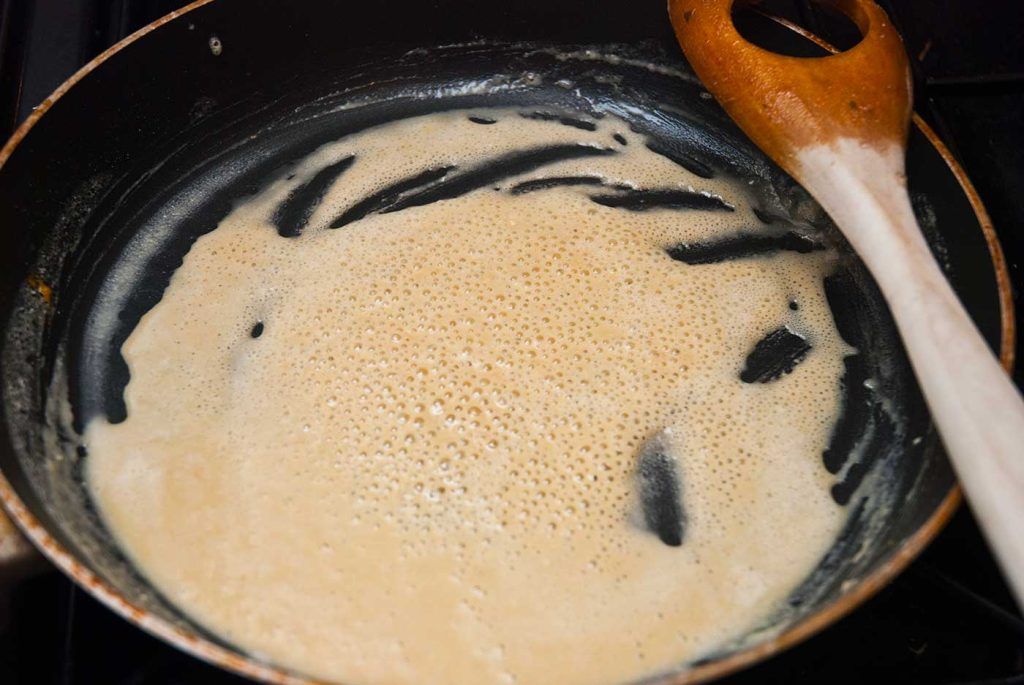 Flour frying in melted butter to make a roux, just beginning to turn golden.