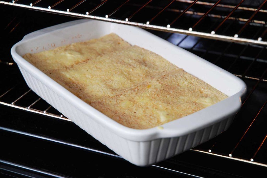 Bread and butter pudding in dish fully soaked with egg mixture.