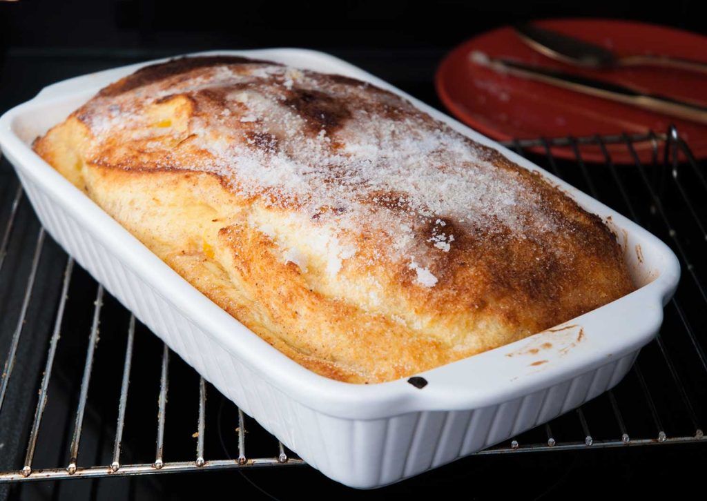 Bread and butter pudding after extra baking, topped with sugar.