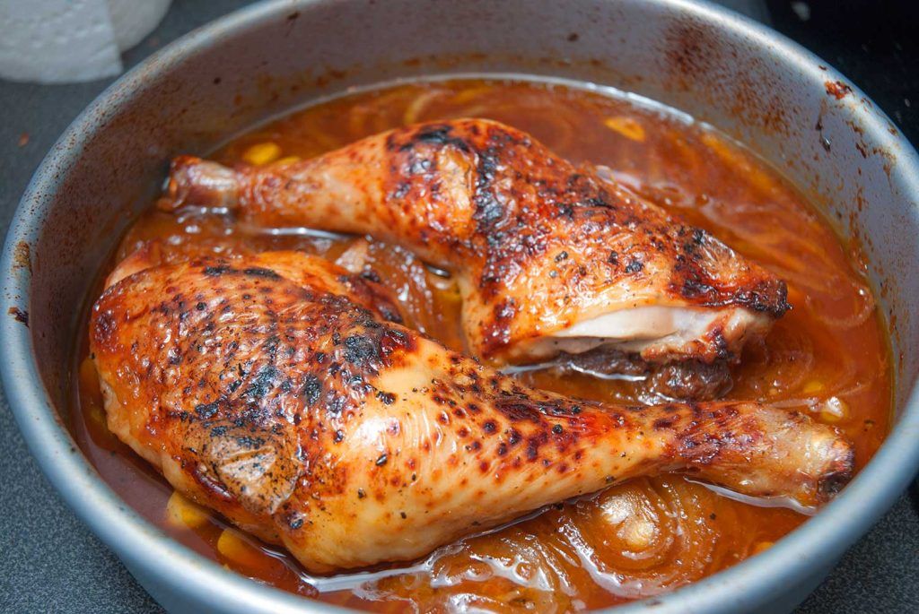 Oven-baked chicken legs just after removing the foil, with the Texas-style BBQ sauce not yet reduced.
