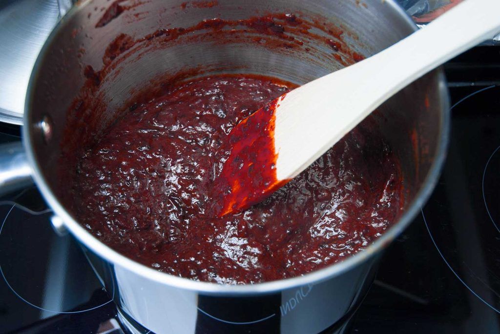 Smooth, dark prune jam in a saucepan after blending.