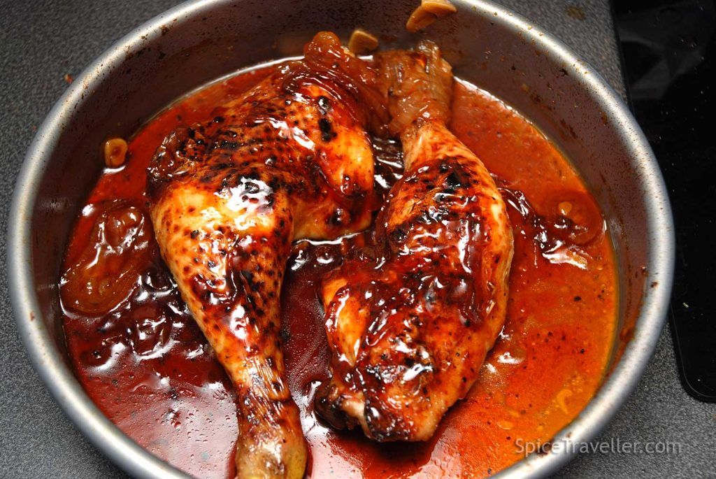 Oven-baked chicken legs fully cooked and coated in a sticky Texas-style BBQ sauce.