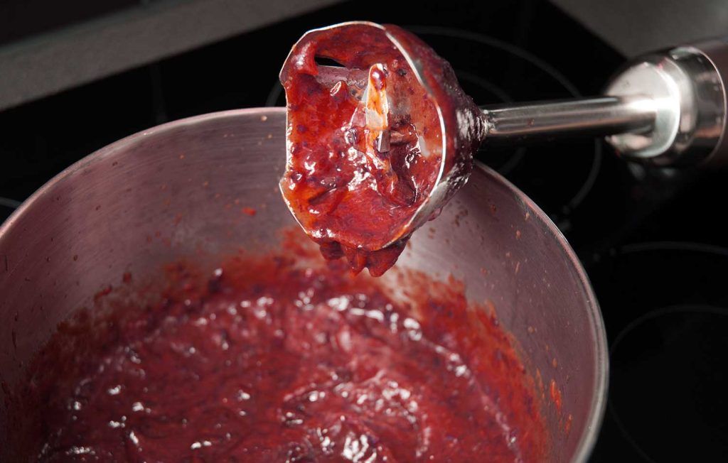Prunes blended to a smooth purée with a stick blender in a saucepan.